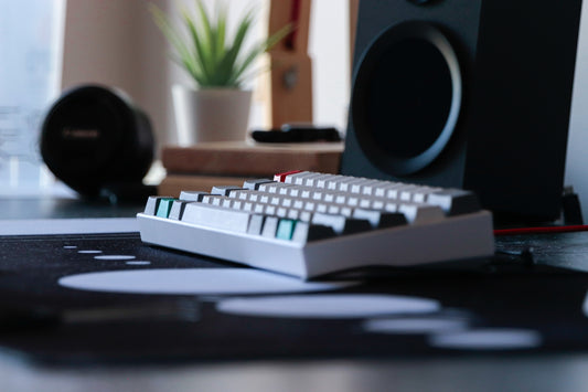 a computer keyboard sitting on top of a desk